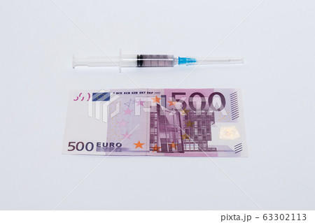 Syringe vaccine and euro bills. Expensive medicine concept. 63302113
