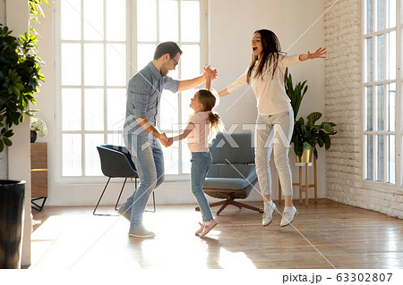 Overjoyed family of three having fun together. 63302807