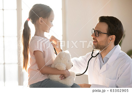 Little patient girl visiting pediatrician for checkup. Little patient girl visiting pediatrician for checkup. 63302905