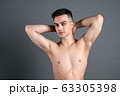 Sexy young man posing in studio. Gray background 63305398