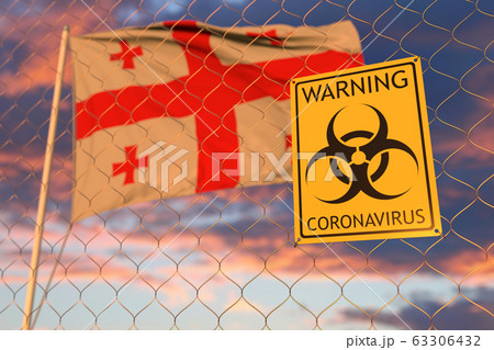 Coronavirus biohazard sign against the Georgian flag. Restricted entry or quarantine in Georgia. Conceptual 3D rendering Coronavirus biohazard sign against the Georgian flag. Restricted entry or quarantine in Georgia. Conceptual 3D rendering 63306432