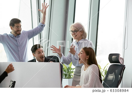 Overjoyed colleagues have fun celebrating success in office 63308984