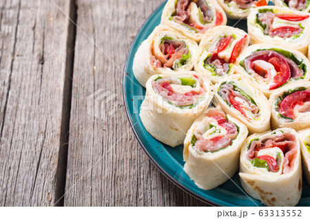 Sliced sandwich tortilla with vegetables and ham Sliced sandwich tortilla with vegetables and ham 63313552