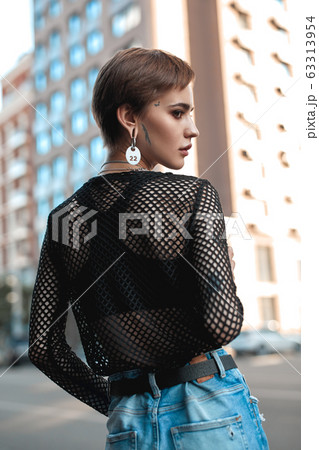 Urban Style. Young stylish woman standing outdoors looking asidep ensive back view close-up 63313954