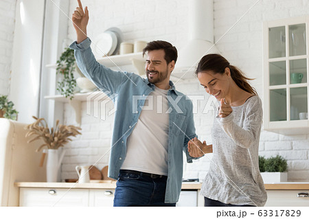 Happy loving couple dancing in modern kitchen together 63317829