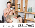Naked sexy guy works at home with laptop 63317903