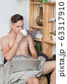 Naked sexy guy works at home with laptop 63317910