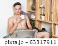 Naked sexy guy works at home with laptop 63317911