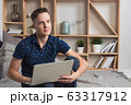 Young happy freelancer works at home with laptop 63317912