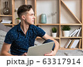 Young happy freelancer works at home with laptop 63317914