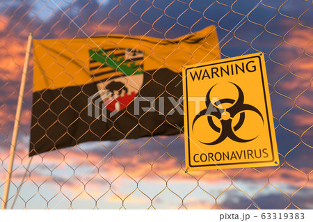 Biohazard coronavirus sign against flying flag of Saxony-Anhalt, a state of Germany. Quarantine related 3D rendering Biohazard coronavirus sign against flying flag of Saxony-Anhalt, a state of Germany. Quarantine related 3D rendering 63319383