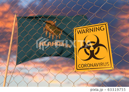 Biohazard coronavirus sign against flying flag of Oklahoma. Quarantine related 3D rendering Biohazard coronavirus sign against flying flag of Oklahoma. Quarantine related 3D rendering 63319755