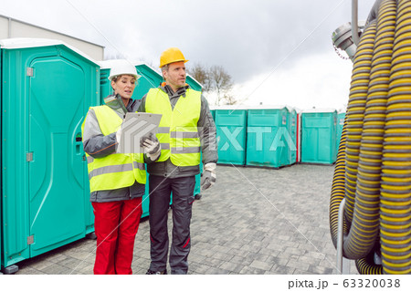 Workers inspecting mobile toilet before shipment Workers inspecting mobile toilet before shipment 63320038