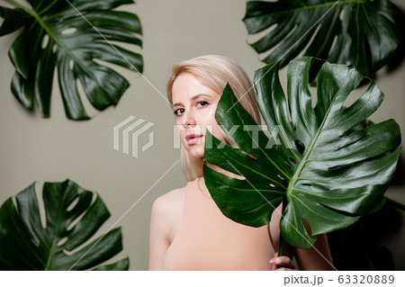 Blonde woman in flesh-colored clothing with palm Blonde woman in flesh-colored clothing with palm 63320889