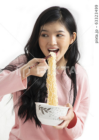 Girl enjoy eating while using chopsticks to hold Girl enjoy eating while using chopsticks to hold 63323499