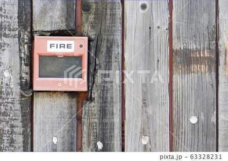 Red Fire alarm on the wooden wall background 63328231