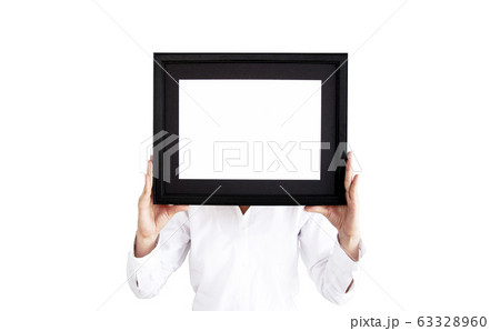 Woman in white shirt holding a photo frame.  63328960