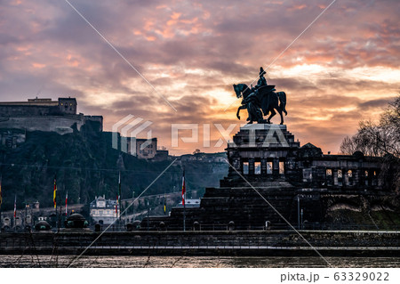 Colorful Sunrise burning sky Koblenz City historic monument German Corner where river rhine and mosele flow together 63329022