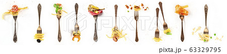Italian food collage. Pasta design elements. Many forks with pasta and various addings, shot from the top on a white background 63329795