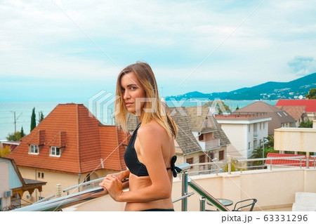 Beautiful tanned woman portrait at resort with beautiful view 63331296