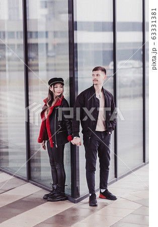 Loving couple in jacket holding hands 63331381