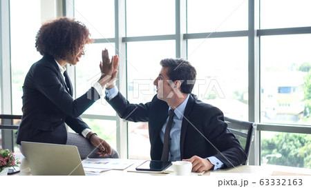 Hispanic and black interracial colleague high five congratulate work 63332163