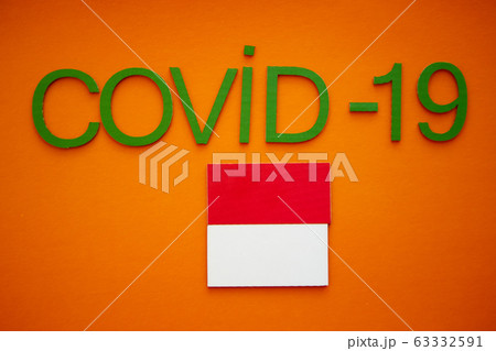 Flag of Indonesia And Word COVID-19 made of green cardboard letters, isolated on orange background. World Health Organization WHO introduced new official name for Coronavirus disease named COVID-19 Flag of Indonesia And Word COVID-19 made of green cardboard letters, isolated on orange background. World Health Organization WHO introduced new official name for Coronavirus disease named COVID-19 63332591