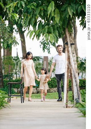 Happy family walking in park 63333110