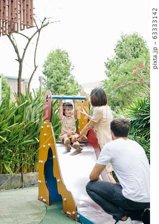 Parents and kid at playground 63333142