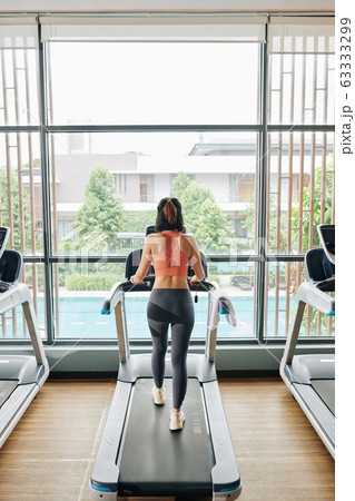 Woman walking on treadmill 63333299