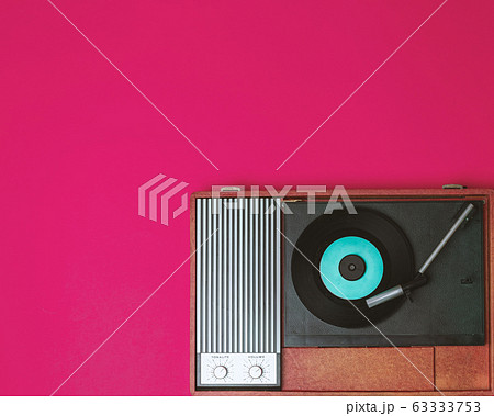 Vintage vinyl player and turnable on a fuchsia Vintage vinyl player and turnable on a fuchsia 63333753