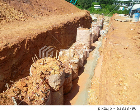 Bore pile cut to level by the construction workers. It will continue by pile cap and ground beam works. Bore pile cut to level by the construction workers. It will continue by pile cap and ground beam works. 63333796