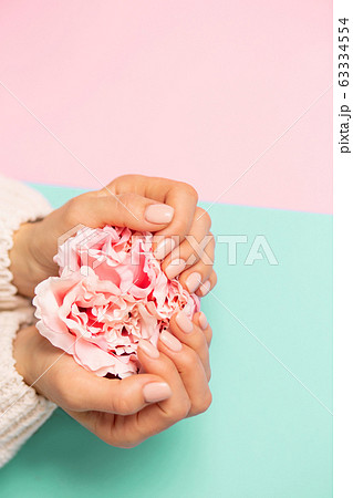 Beautiful woman's hands on background Beautiful woman's hands on background 63334554