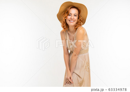 Cheerful woman with fair red hair in beautiful dress smiles, picture isolated on white background 63334978