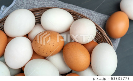 Chicken egg and duck egg on a black wooden table. Chicken egg and duck egg on a black wooden table. 63335773