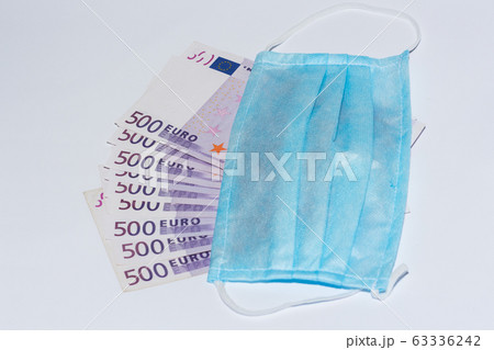 Protective medical mask and euro bills. Expensive 63336242
