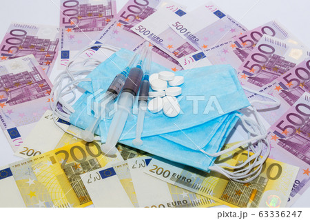Tablets, protective mask, syringe and euro bills. Tablets, protective mask, syringe and euro bills. 63336247