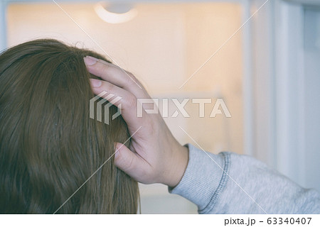 Worried woman looking at empty refrigerator Worried woman looking at empty refrigerator 63340407