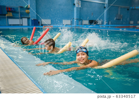 Children swimming group lies on back in the pool Children swimming group lies on back in the pool 63340517