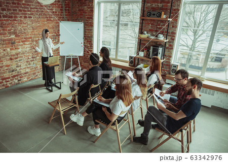 Female muslim speaker giving presentation in hall at university workshop 63342976