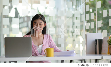 A young female student with a laptop and coffee, A young female student with a laptop and coffee, 63344466