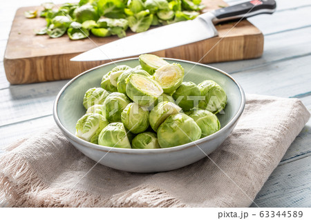 Fresh brusseles sprouts in bowl on kitchen table 63344589