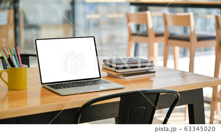 Cropped shot of Laptop with notebooks and 63345020