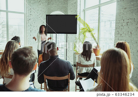 Female african-american speaker giving presentation in hall at university workshop 63346234