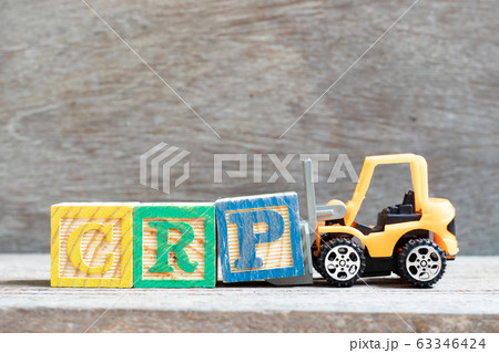 Toy forklift hold letter block P to complete word CRP (abbreviation of C-Reactive Protein Test) on wood background 63346424