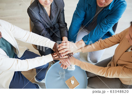 People Joining Hands in Support Group 63348620