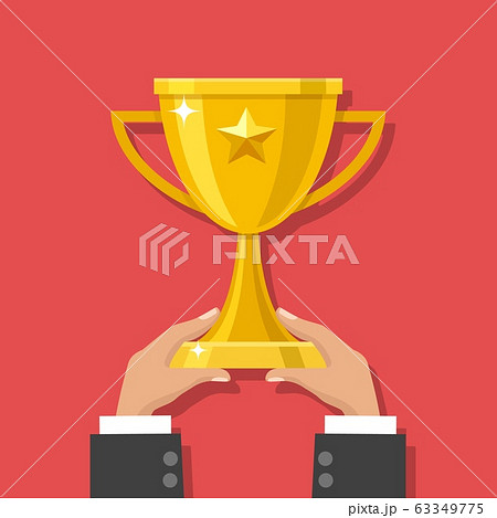 Hands holding gold trophy cup 63349775