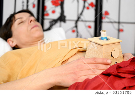 Alternative therapist applying moxibustion a traditional chinese medicine method. Alternative therapist applying moxibustion a traditional chinese medicine method. 63351709