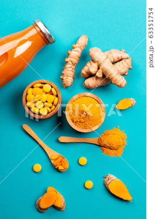 Turmeric in different conditions: fresh, dry root, pills, powder and cut plant. Turmeric in different conditions: fresh, dry root, pills, powder and cut plant. 63351754