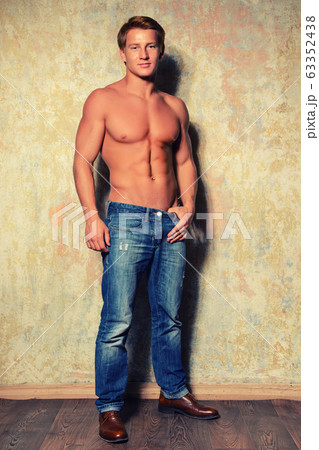 Portrait of a happy athletic man with muscular 63352438
